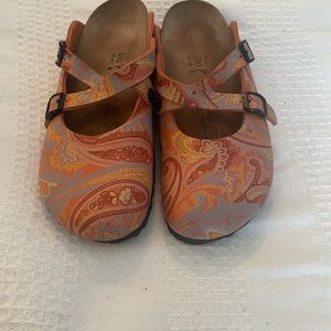 Birki’s (Birkenstock) orange paisley mules.